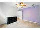 Bedroom features tile floor, lilac accent wall, and closet at 7139 Cedarcrest Blvd, Lakeland, FL 33810