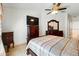 Bedroom features a ceiling fan, dresser, and window with valance at 7139 Cedarcrest Blvd, Lakeland, FL 33810
