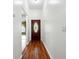 Entryway featuring hardwood floors, a decorative front door, and neutral paint at 7139 Cedarcrest Blvd, Lakeland, FL 33810