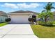 Well-maintained home with a two-car garage and manicured lawn at 7139 Cedarcrest Blvd, Lakeland, FL 33810