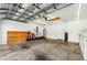 Spacious three-car garage with high ceiling, storage racks, and garage door openers at 7139 Cedarcrest Blvd, Lakeland, FL 33810