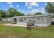 Rear exterior featuring a patio and two sets of stairs, perfect for outdoor enjoyment at 7202 Glen Meadow Dr, Lakeland, FL 33810