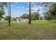 Expansive backyard with lush greenery, mature trees, and a charming fence at 7202 Glen Meadow Dr, Lakeland, FL 33810