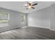 Inviting bedroom with two windows, neutral walls, and stylish wood-look flooring at 7202 Glen Meadow Dr, Lakeland, FL 33810