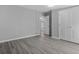 Bedroom boasting neutral walls, wood-look floors, and doorway views at 7202 Glen Meadow Dr, Lakeland, FL 33810