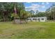 Spacious property with well-maintained home, manicured lawn, and an American flag at 7202 Glen Meadow Dr, Lakeland, FL 33810