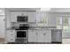 Modern kitchen with stainless steel appliances, granite counters, and white cabinets at 7202 Glen Meadow Dr, Lakeland, FL 33810