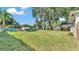 Expansive backyard with lush green grass, storage sheds, and an open space perfect for outdoor activities at 747 E Bella Vista St, Lakeland, FL 33805