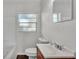 Clean bathroom with a tub, toilet, and vanity with a modern faucet and fixtures at 747 E Bella Vista St, Lakeland, FL 33805