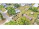 Property with mature trees, a home, and a garage in a residential neighborhood at 828 E Valencia St, Lakeland, FL 33805