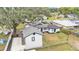 Birds eye view of home with white fence, detached garage, and mature trees at 828 E Valencia St, Lakeland, FL 33805