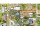 Aerial view showing the property lines, home, detached garage, and surrounding neighborhood at 828 E Valencia St, Lakeland, FL 33805