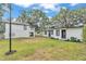 Spacious backyard featuring a combination of lush greenery and modern exterior design at 828 E Valencia St, Lakeland, FL 33805