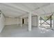 Expansive unfinished basement featuring open layout, concrete floor, and white painted overhead beams at 828 E Valencia St, Lakeland, FL 33805
