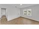 This bedroom features wood-look floors, neutral colors, a door and large window at 828 E Valencia St, Lakeland, FL 33805