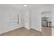 Bright bedroom featuring white walls and trim, neutral floors, and open to the rest of the house at 828 E Valencia St, Lakeland, FL 33805