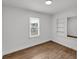 Bright bedroom with white trim, neutral walls, light wood flooring, and built in shelving at 828 E Valencia St, Lakeland, FL 33805