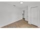 Spacious bedroom with light wood floors, white walls, and closet access at 828 E Valencia St, Lakeland, FL 33805