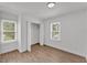 Sun-filled bedroom features new wood flooring, closet, and dual windows, providing a light airy atmosphere at 828 E Valencia St, Lakeland, FL 33805