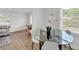 Open dining area with modern table, bright windows, and a view into the living room at 828 E Valencia St, Lakeland, FL 33805