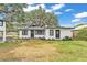 Charming exterior of a renovated home featuring fresh landscaping and a well-manicured lawn at 828 E Valencia St, Lakeland, FL 33805
