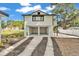 Unique home design featuring a stilt-style construction and fresh landscaping at 828 E Valencia St, Lakeland, FL 33805