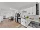 Updated kitchen with stainless steel appliances, white cabinets, and an adjacent dining area at 828 E Valencia St, Lakeland, FL 33805