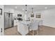 Eat-in kitchen featuring an island with bar seating, pendant lights, white cabinets, and stainless steel appliances at 828 E Valencia St, Lakeland, FL 33805