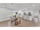 Bright, open kitchen and dining area featuring white cabinets, stainless steel appliances, and a breakfast bar at 828 E Valencia St, Lakeland, FL 33805