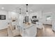 Stylish eat-in kitchen featuring white cabinets, stainless steel appliances, and an island with seating at 828 E Valencia St, Lakeland, FL 33805
