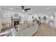 Bright and airy living room connected to the kitchen featuring a fireplace and modern ceiling fan at 828 E Valencia St, Lakeland, FL 33805
