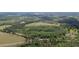 Aerial shot emphasizing the boundary lines of a large property with a home and outbuildings surrounded by woodlands at 8337 Fussell Rd, Polk City, FL 33868