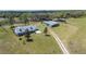 Expansive property featuring a well-maintained home, outbuildings, and a long driveway leading to the residence at 8337 Fussell Rd, Polk City, FL 33868