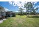 Large backyard featuring a screened-in porch and mature trees at 8337 Fussell Rd, Polk City, FL 33868