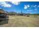 Expansive backyard featuring open space, storage containers, and utility buildings at 8337 Fussell Rd, Polk City, FL 33868