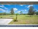 Expansive backyard view from the covered porch, showcasing the lush landscaping and open space at 8337 Fussell Rd, Polk City, FL 33868