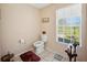 Powder room featuring a toilet, small window with blinds, and tile flooring at 8337 Fussell Rd, Polk City, FL 33868
