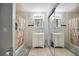 Bright bathroom with double sink vanity, mirrors, a shower with a curtain and tile floors at 8337 Fussell Rd, Polk City, FL 33868