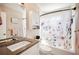 Bright bathroom with a floral shower curtain and a modern vanity at 8337 Fussell Rd, Polk City, FL 33868