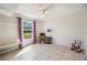Bedroom featuring a ceiling fan, tile floors, and a large window with lots of natural light at 8337 Fussell Rd, Polk City, FL 33868