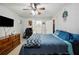 Bedroom with tile floor, wooden dresser, desk, and an open view of an ensuite bathroom at 8337 Fussell Rd, Polk City, FL 33868