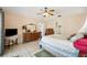 Comfortable bedroom with ceiling fan and dresser with an elegant mirror at 8337 Fussell Rd, Polk City, FL 33868