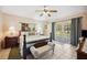 Bright bedroom with large windows, bed, bench, and bedside tables at 8337 Fussell Rd, Polk City, FL 33868