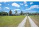 Well-maintained single-story home with a long driveway and spacious front yard at 8337 Fussell Rd, Polk City, FL 33868