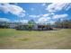 View of metal utility building with covered areas and ample outdoor space at 8337 Fussell Rd, Polk City, FL 33868
