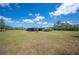 Wide shot of property, featuring metal building, expansive yard, and plentiful storage at 8337 Fussell Rd, Polk City, FL 33868