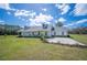 Spacious home with a large manicured lawn, covered front porch, and a long driveway at 8337 Fussell Rd, Polk City, FL 33868