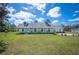 Inviting home with a spacious front yard, covered porch, established landscaping, and dormer windows at 8337 Fussell Rd, Polk City, FL 33868