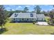 Charming single-story home featuring a well-manicured front lawn and classic dormer windows at 8337 Fussell Rd, Polk City, FL 33868