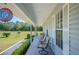 Inviting covered front porch with seating overlooking the expansive front yard at 8337 Fussell Rd, Polk City, FL 33868